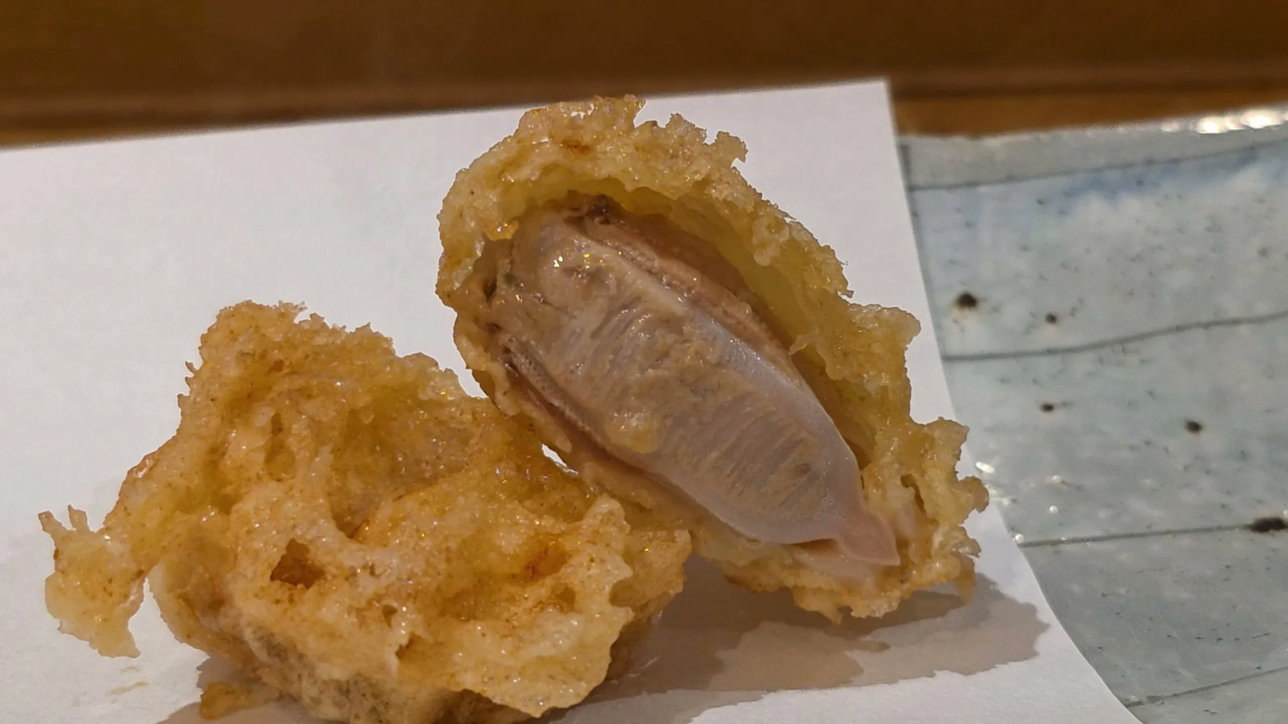 Hamaguri clam tempura split open beside a second piece